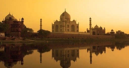 Taj Mahal at sunset reflected in the calm Yamuna River