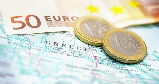 Euro coins on a map of Greece