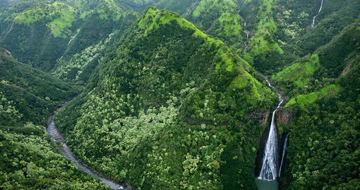 Soar high in the skies while admiring the Manawaiopuna Falls, known widely for their appearance in the Jurassic Park franchise
