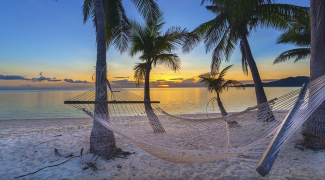 Fiji beach sunset with hammock