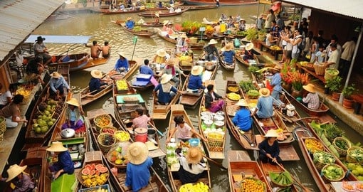 Glide along the waterways and experience what Bangkoks floating market has to offer on your Trip to Thailand