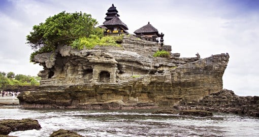 Embrace your spiritual side at Tanah Lot, a rock formation surrounded by the sea that hosts a Hindu temple