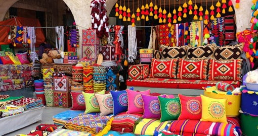 Delve deep into the Qatari culture and traditions as you explore the local Souq Waqif market that boasts a range of colorful textiles