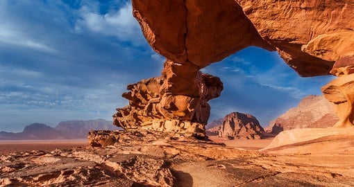Journey through the Wadi Rum desert with its rock bridges, canyons, and stunning sand dunes