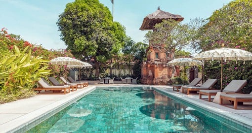 Experience tranquility as you relax by the pool at The Pavilions Bali resort