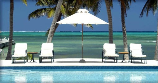 Relax by the Victoria House pool on your Belize Vacation