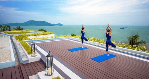 Experience calm and tranquil vibes as you take on a Yoga session with an ocean view at the relaxing Amatara Wellness Resort