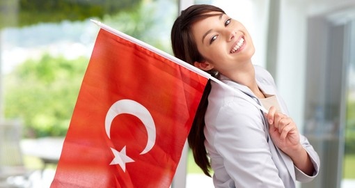 Portrait of a young woman holding a Turkish flag