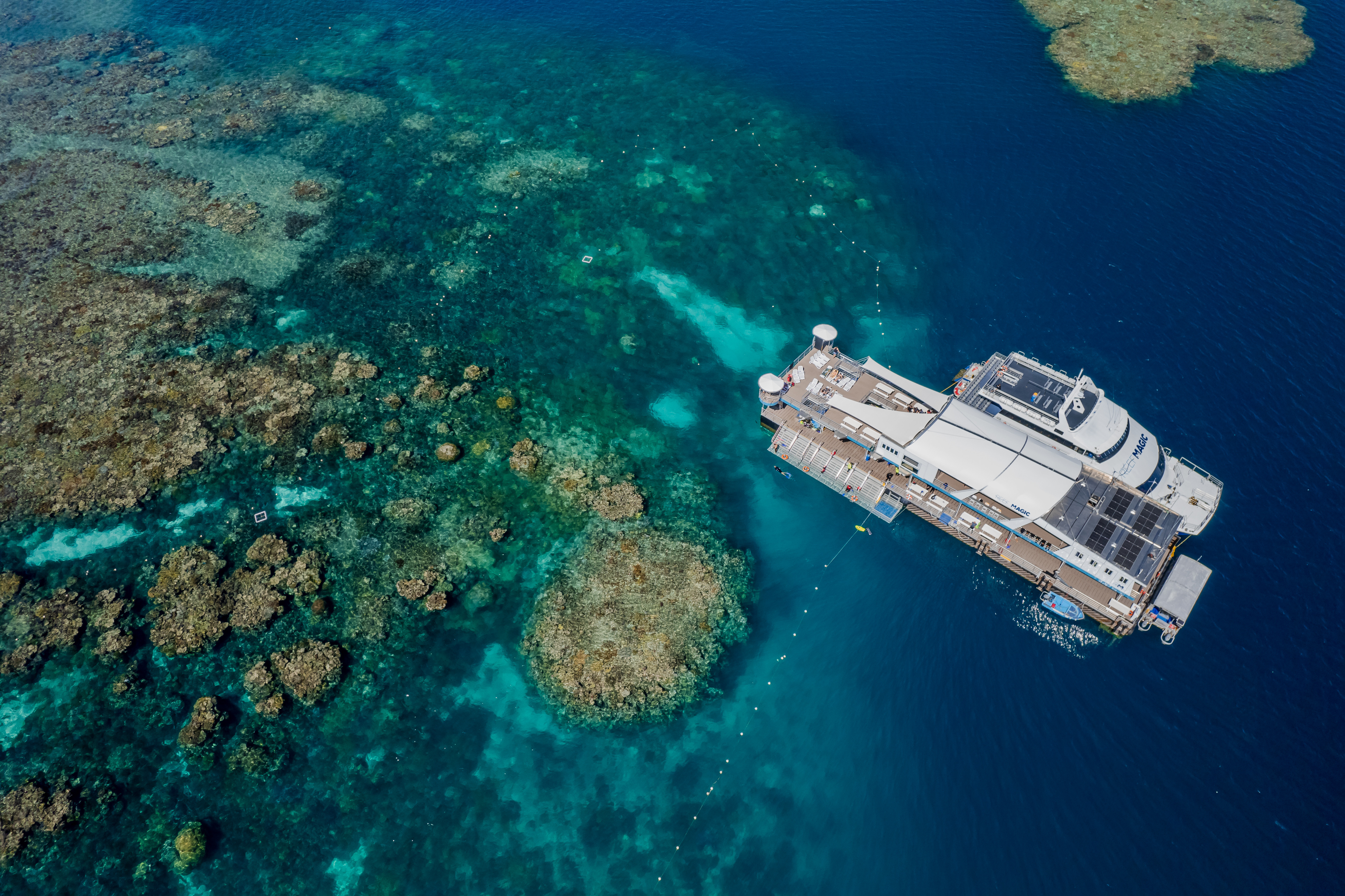 Aerial view of Great Barrier Reef with cruise vessel