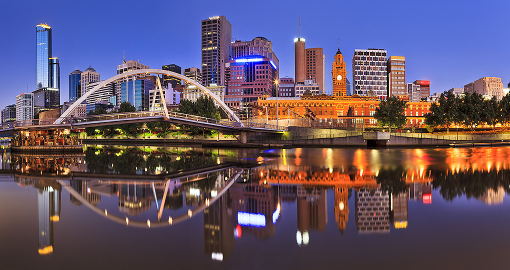 The Melbourne skyline at dusk. Bridge and skyscrapers reflecting in the river