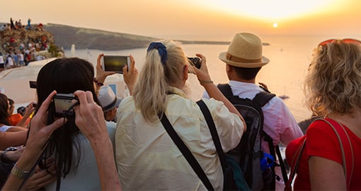 group of tourists taking a picture of the sunset